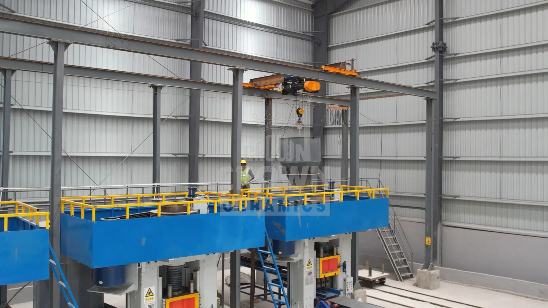 Raw material hopper craned onto the press deck above the brick presses